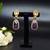 Elegant oval drop earrings with triple gemstone design