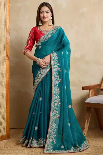 Bewitching teal sequins & thread embroidered fendy chiffon silk saree with red mono banglory silk blouse