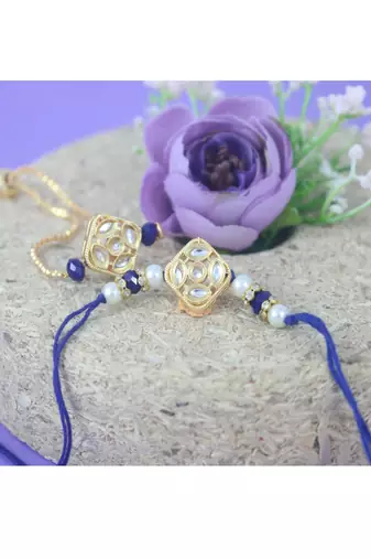 Gold-plated set of 2 handmade unisex rakhi for bhaiya bhabhi with roli chawal and written greeting note.