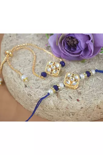 Gold-plated set of 2 handmade unisex rakhi for bhaiya bhabhi with roli chawal and written greeting note.
