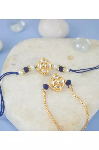 Gold-plated set of 2 handmade unisex rakhi for bhaiya bhabhi with roli chawal and written greeting note.