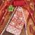 Elegant rust embroidered organza salwar suit with floral motifs & scallop detailing