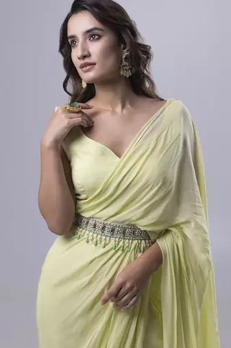 Green georgette plain saree with embroidered blouse & belt