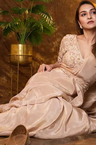 Beige tissue plain saree with embroidered blouse & belt