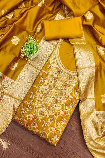 Elegant golden jacquard salwar suit with heavy embroidery and rich dupatta