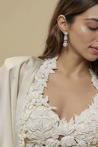 White satin plain cape and skirt paired with emobroidered blouse
