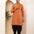 Men rust orange textured straight kurta with black dhoti pants set