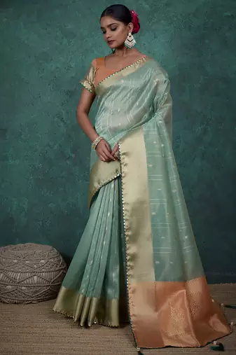 Light green linen blend self woven butta all over, a grand broad patta & sequins woven pallu saree with blouse