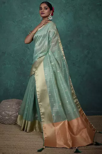 Light green linen blend self woven butta all over, a grand broad patta & sequins woven pallu saree with blouse