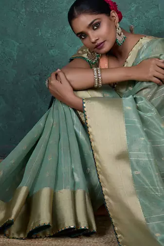 Light green linen blend self woven butta all over, a grand broad patta & sequins woven pallu saree with blouse