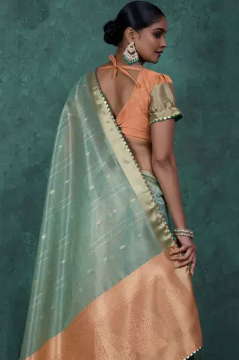 Light green linen blend self woven butta all over, a grand broad patta & sequins woven pallu saree with blouse
