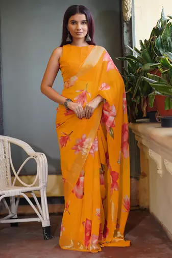 Bright orange chiffon floral print golden zari line border saree with unstitched blouse piece