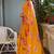 Bright orange chiffon floral print golden zari line border saree with unstitched blouse piece