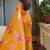 Bright orange chiffon floral print golden zari line border saree with unstitched blouse piece