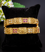 Regal elephant motif gold bangles with enamel detailing