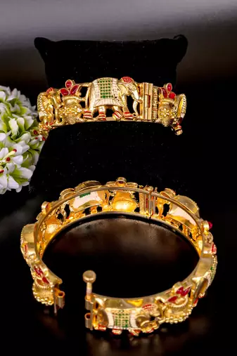 Regal elephant motif gold bangles with enamel detailing