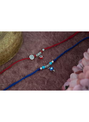Combo of evil eye and smiley charm unisex rakhi for bhaiya bhabhi with roli chawal and written greeting note. 1