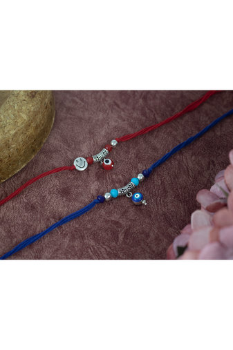 Combo of evil eye and smiley charm unisex rakhi for bhaiya bhabhi with roli chawal and written greeting note.