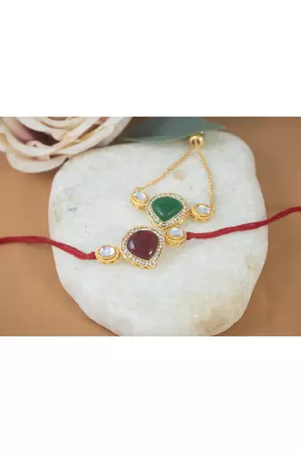 Combo of kundan rakhi and bracelet set for bhaiya bhabhi with roli chawal and written greeting note.