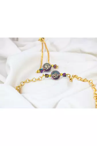 Spiritual om rakhi and bracelet set for bhaiya bhabhi golden chain design with crystal beads