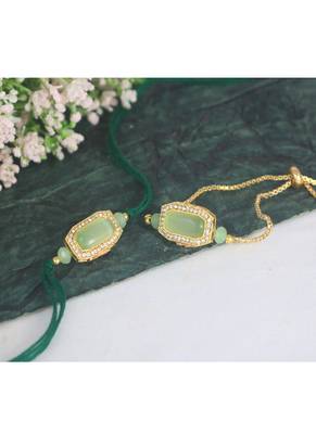 Mint green stone and crystal-studded unisex rakhi set for bhaiya bhabhi with roli chawal and written greeting note. 1