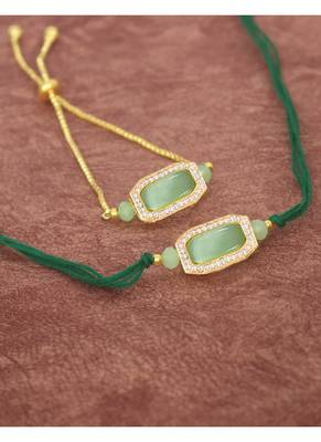 Mint green stone and crystal-studded unisex rakhi set for bhaiya bhabhi with roli chawal and written greeting note. 2