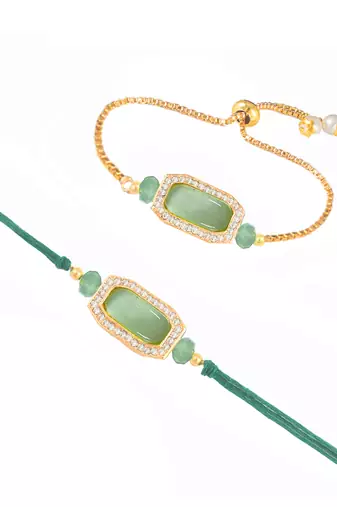 Mint green stone and crystal-studded unisex rakhi set for bhaiya bhabhi with roli chawal and written greeting note.