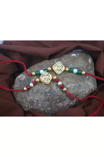 Traditional kundan with pearl and beads rakhi set for bhaiya with roli chawal and written greeting note.
