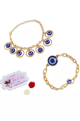 Stylish gold plated combo of evil eye protective rakhi for bhaiya bhabhi with roli chawal and written greeting note.
