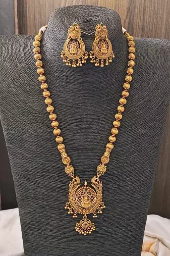 Antique gold plated temple jewelry necklace set with lakshmi pendant and earrings for bridal and ethnic wear