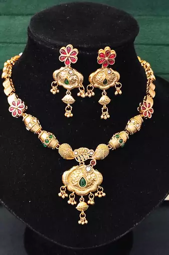 Ethnic gold floral necklace set with red and green enamel accents