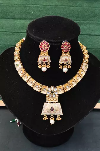 Temple inspired bell pendant necklace set with pearl drops