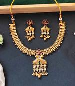 Traditional floral pendant necklace set with red and green stones and dangling beads