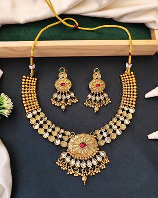 Beautiful gold-plated kundan necklace and earrings set with red and green stones, pearl accents for her 1