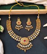 Beautiful gold-plated kundan necklace and earrings set with red and green stones, pearl accents for her