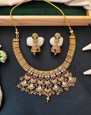 Traditional kundan choker necklace set with red and green stones, gold-plated jhumka earrings 1
