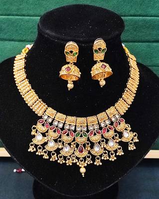 Traditional kundan choker necklace set with red and green stones, gold-plated jhumka earrings 3