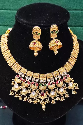Traditional kundan choker necklace set with red and green stones, gold-plated jhumka earrings