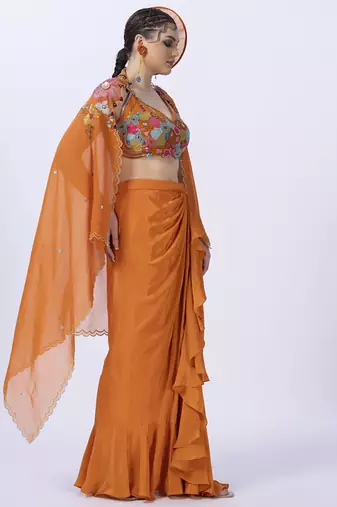 Orange embroidered organza blouse paired with dhoti & shrug