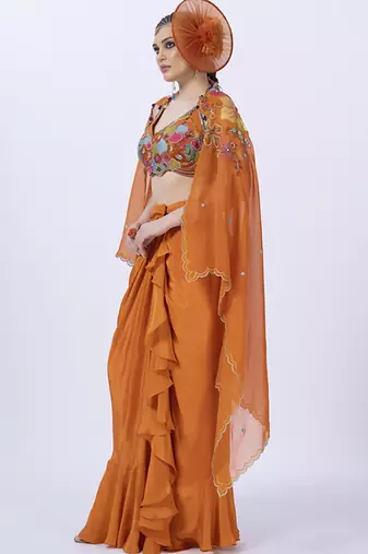 Orange embroidered organza blouse paired with dhoti & shrug