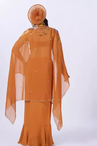 Orange embroidered organza blouse paired with dhoti & shrug