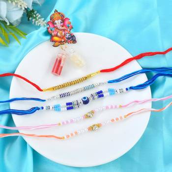 Rakhi for bhaiya bhabhi-pearl, cz and evil eye rakhi set for rakshabandhan with silver coin (pack of 5) 1