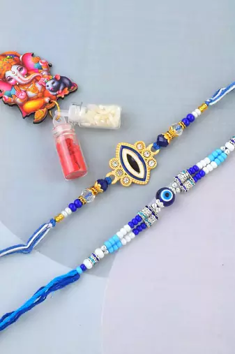 Ceramic evil eye combo rakhi for bhaiya bhabhi with 50% silver content lakshmi ganesh coin (pack of 2)