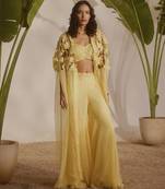 Yellow plain organza pant paired with embroidered blouse and cape