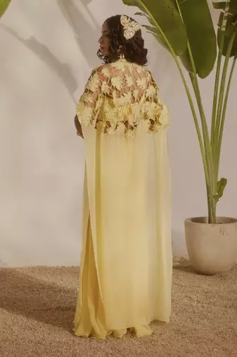 Yellow plain organza pant paired with embroidered blouse and cape