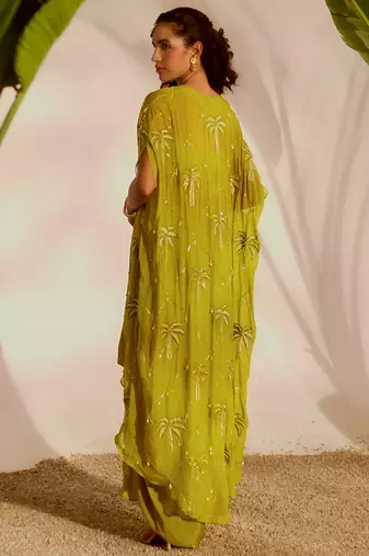 Green plain organza pant paired with embroidered blouse and cape