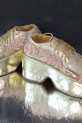 Gold leather embroidered sneakers