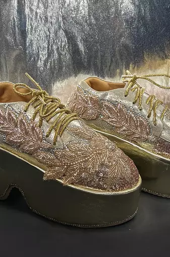 Gold leather embroidered sneakers