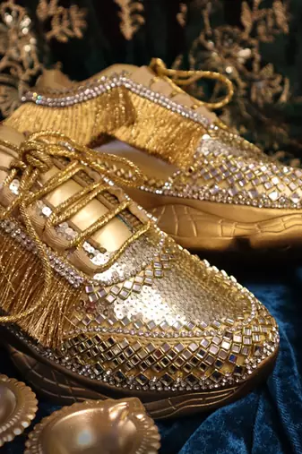 Gold leather embroidered sneakers