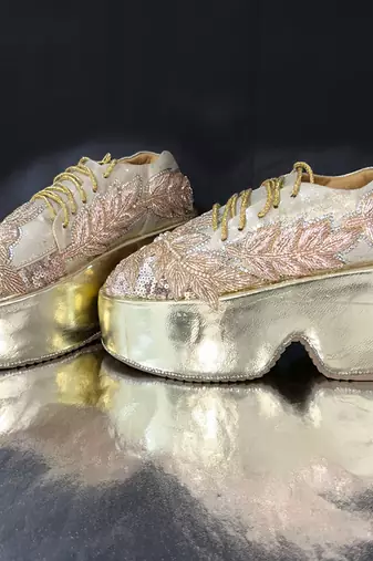 Gold leather embroidered sneakers